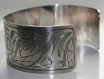 Tattoostyle engraves cuff bracelet.